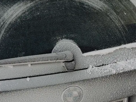 Frost on the rear window and wiper of a car