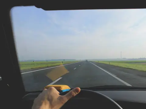 Open highway seen through a clean windshield