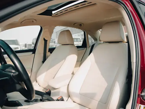 Light seats seen through an open door with clear side glass