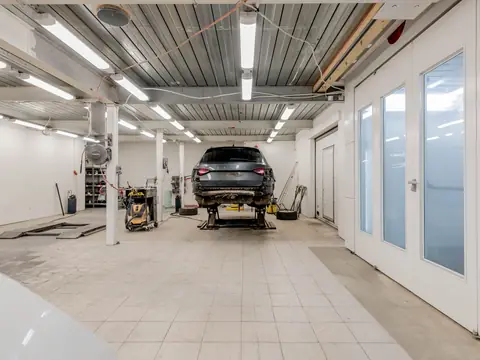 Bright empty service hall with a car at the far end